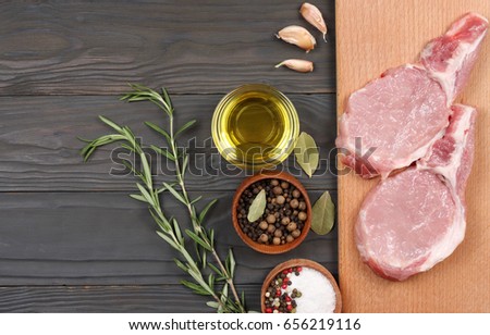 fresh raw meat with spices on wooden table. top view with copy space