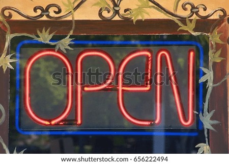 Open Red and Blue Neon Sign in Restaurant Window