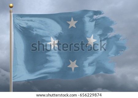 Micronesia Flag with torn edges in front of a stormy sky