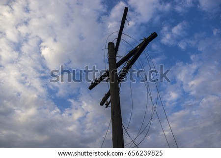 A Telegraph pole with torn wires