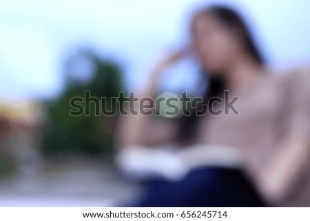 blur picture of lady is reading a book in relaxation time
