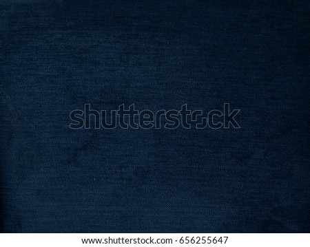 Navy blue background, Texture of dark blue plush fabric, dense velvet. Soft, fleecy cloth. Texture of dark denim nappy textile, closeup, vintage