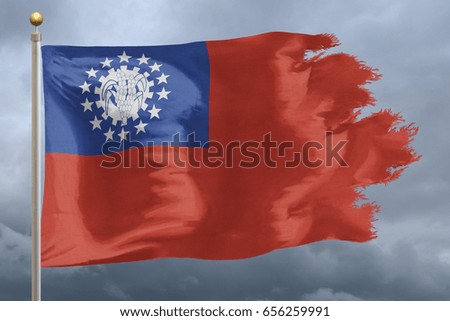 Myanmar Flag with torn edges in front of a stormy sky