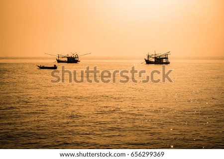 Scenic view of beautiful sunset above the sea. boats on background