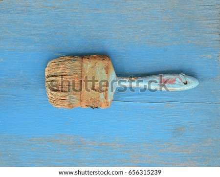 Old paint brush on blue wood