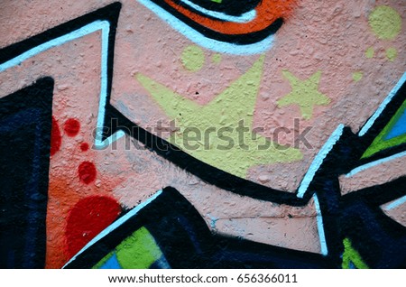 Street art. Colorful graffiti on the wall. Fragment for background. Abstract detail of a graffiti