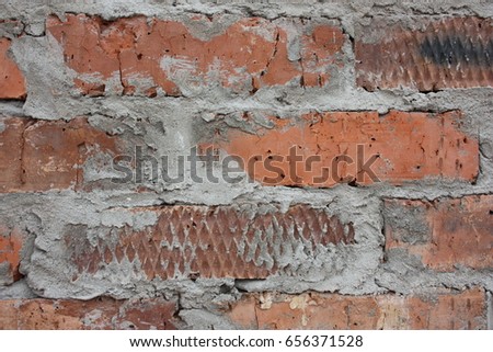 Brick wall. Careless laying of bricks. Cement to perform. Photo for your design