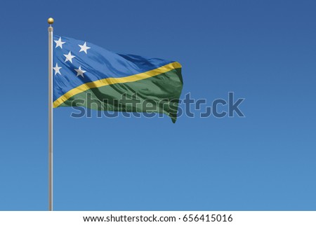 Solomon Islands flag in front of a clear blue sky
