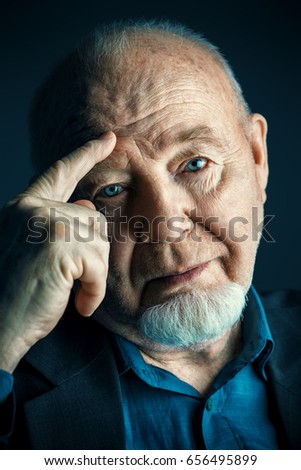 Portrait of old man over black background. Old age concept.