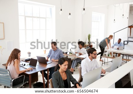 Young business colleagues working at computers in an office Royalty-Free Stock Photo #656504674
