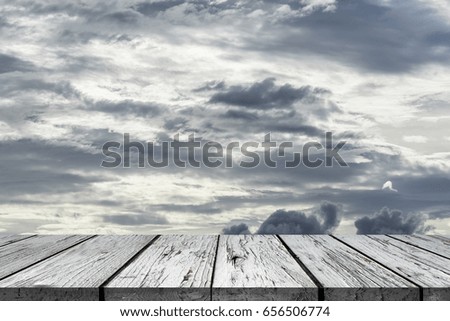 Wooden floor with perspective and stormy cloudy sky