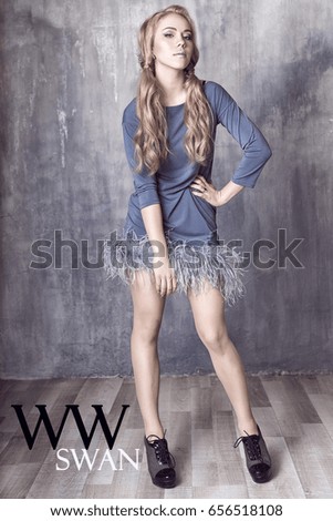Young and emotional woman in fashion dress over glamour background