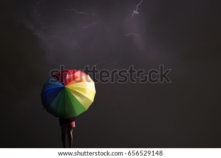 Woman with umbrella in a storm