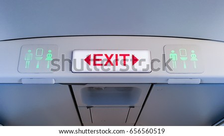 emergency exit sign and toilet sign on airplane