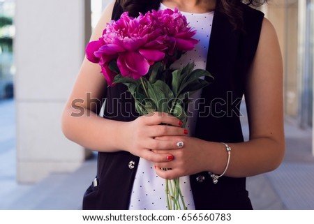 A bouquet of peony in hand girl.