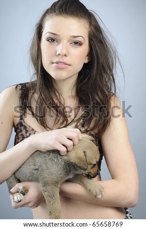 prehistoric woman playing with baby dog