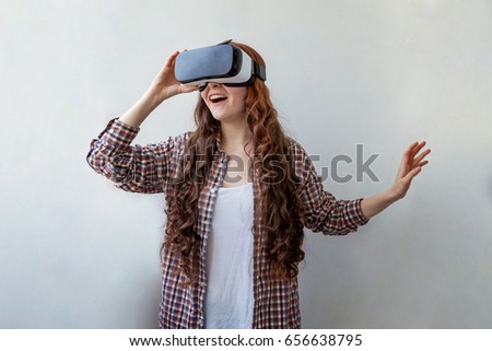 Smile happy young woman using the virtual reality headset on white background