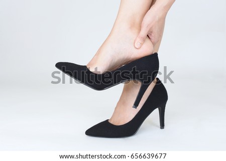 Woman feet pain wear high heel shoes Royalty-Free Stock Photo #656639677