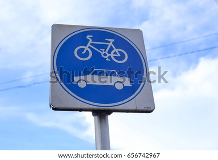 Bicycle and car sign with sky background