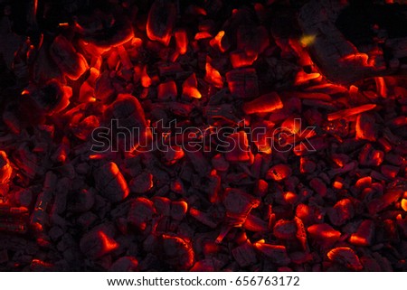 Burning firewood in the fireplace close up, BBQ fire, charcoal background