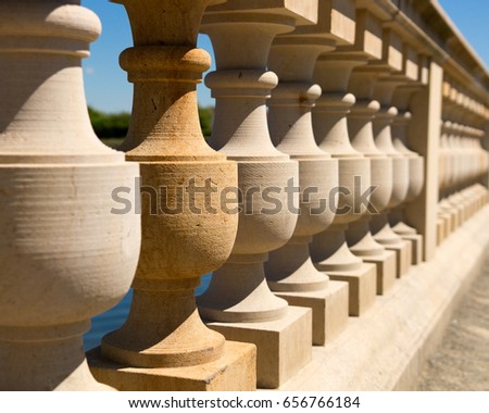 Detail of Ancient stone column railing captured with shallow depth of field/Ancient column railing