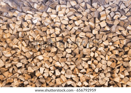 Pile of firewood. Preparation of firewood for the winter. Natural pattern background