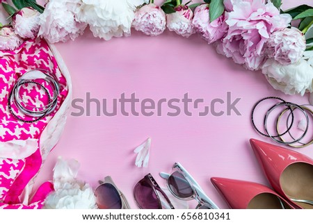 Woman Trendy Fashion Accessories such as Pink Court Shoes, Silk Pink Scarf, Sunglasses and Flowers on Pink Background, Flat Lay, Top View