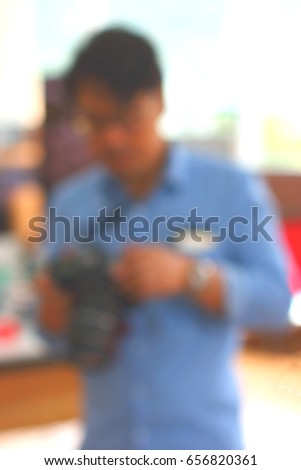 Blurry focus at a man who is watching on camera in shop 