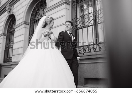 beautiful wedding couple walking around the city in Sunny weather at your wedding