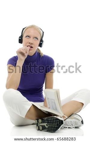 portrait of a young caucasian woman with casual clothing with book and headphones