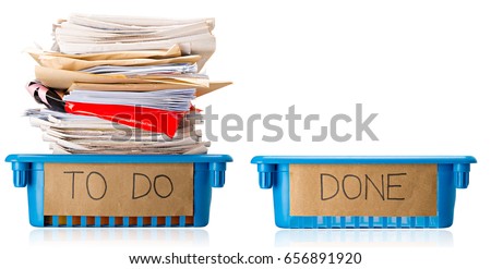 Procrastination - A full To Do tray and an empty Done tray - Overwhelmed - Isolated on white background Royalty-Free Stock Photo #656891920