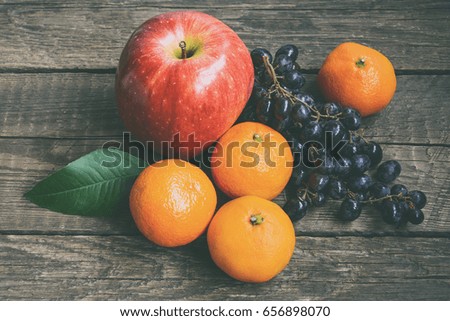 Mixed summer fruits on wooden background