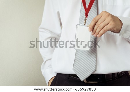 Man holding Identification white blank plastic id card.