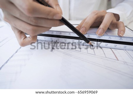 Designers write design drawings on paper.