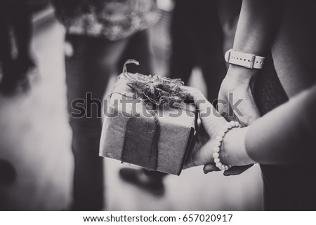 Girl holding a gift with a beautiful ribbon
