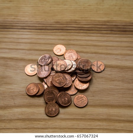 Old Latvian coins on a wooden background. Lats and centimes.