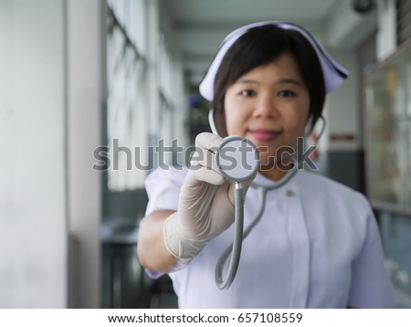 A woman nurse holding Stethoscope