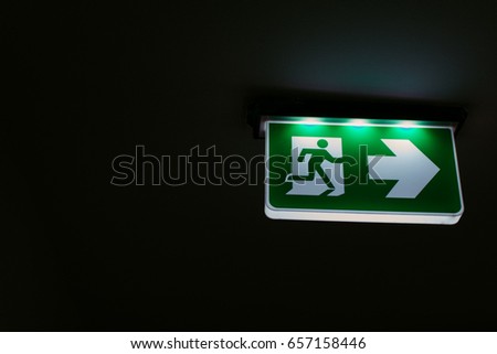 Lighting Emergency Sign with Arrow in the Dark Shadow