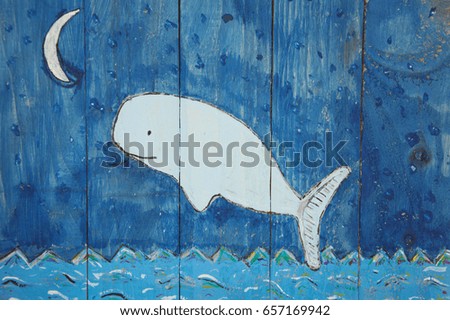 Hand painted and hand drawn white whale with crescent moon and sea on blue wood panel background