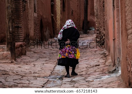 Old woman in Abyaneh village Royalty-Free Stock Photo #657218143