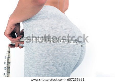 Hand with meter, buttocks and legs of slim woman