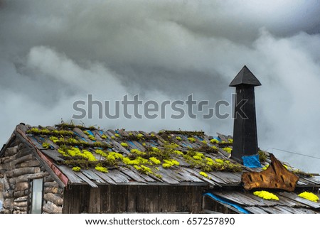 Close up Old House with Chimney on the roof top on rainy season.