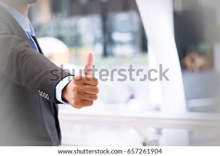 Business Man is giving thumbs up sign