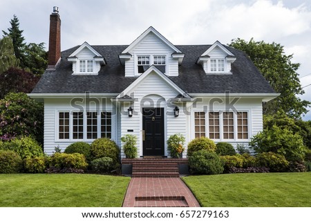 Classic white clapboard house with the red brick sidewalk Royalty-Free Stock Photo #657279163