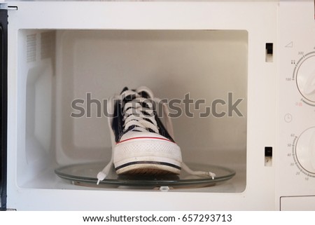 Comic ptcture with a sneaker in a microwave oven