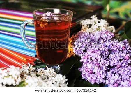 Lilac and flower tea in a glass cup