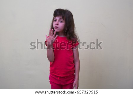 Closeup portrait of young Girl child opening shirt to vent,it's hot. Negative emotion, facial expression, feeling