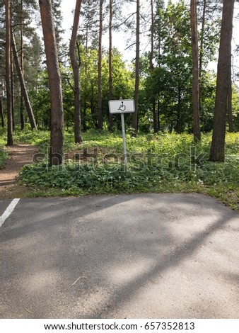 Disabled parking sign for cars at the forest