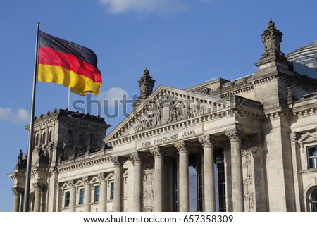 The German Bundestag with flag, a constitutional and legislative building in Berlin, capital of Germany Royalty-Free Stock Photo #657358309