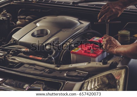 Car service ,fitting a car battery with wrench / soft focus picture 